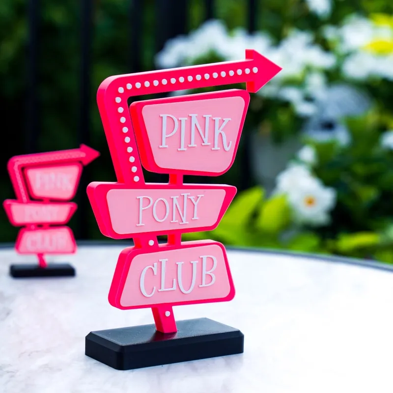Pink retro marquee sign that reads Pink Pony Club